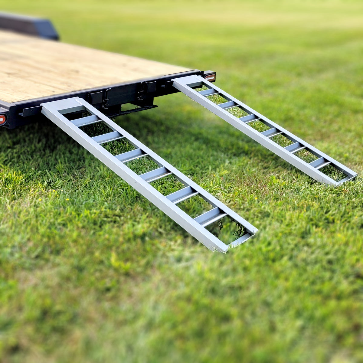 Steel loading ramps deployed from onboard storage